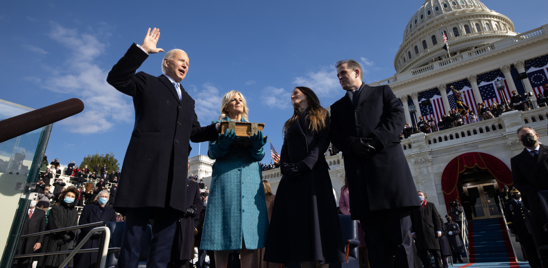 President Biden standing next to Jill Biden being sworn in as President